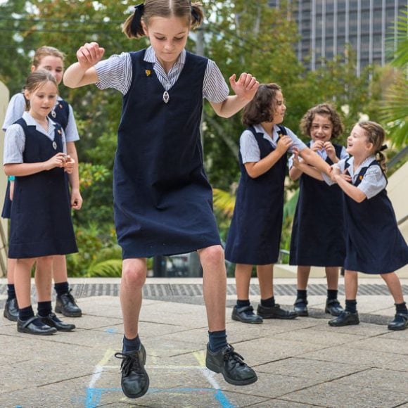 Girls playing hopscotch at school