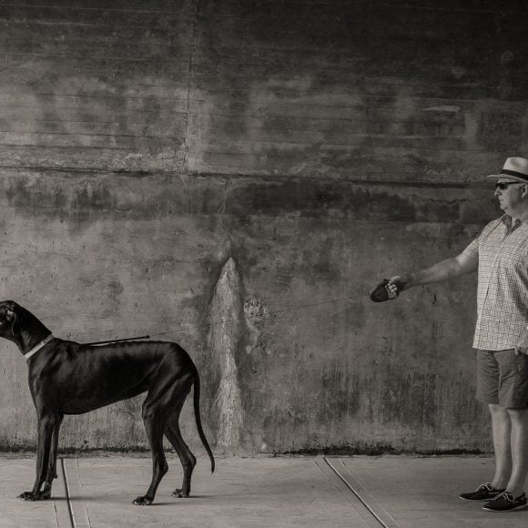 a dog-walker an dog in a tune;l - an original on-location portrait