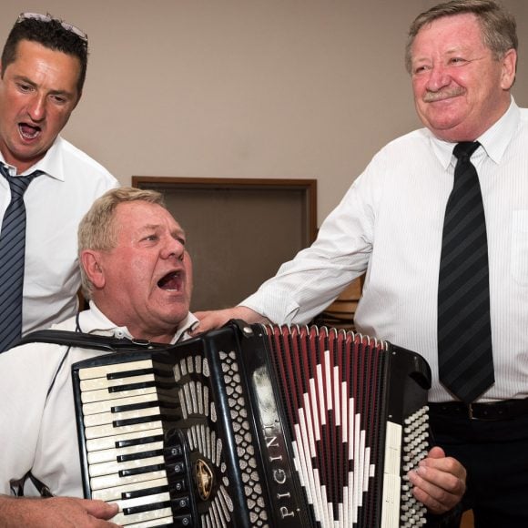 accordion player and two singers